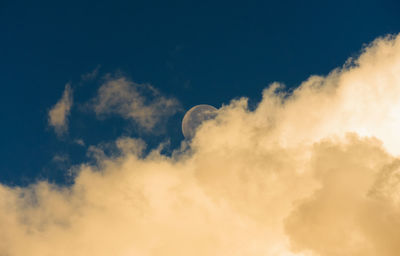 Low angle view of moon against blue sky