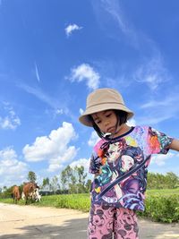 Low angle view of woman holding umbrella 