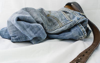 Close-up of jeans on bed at home