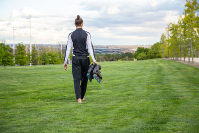 Rear view of man walking on field