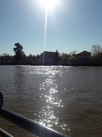 Scenic view of lake against clear sky on sunny day