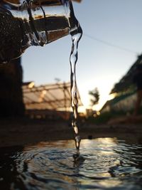 Close-up of icicles against clear sky during sunset