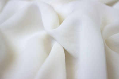 Close-up texture of milky color fabric or cloth in white color. fabric texture of white background.