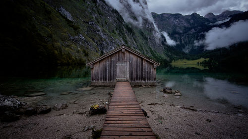 Scenic view of lake by mountain against sky