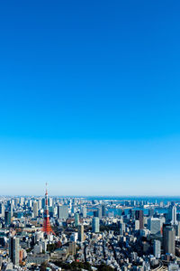 High angle view of buildings against blue sky