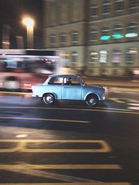 Cars on city street at night