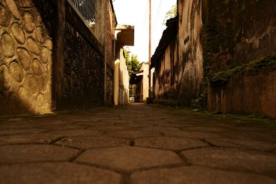 Cobblestone street amidst buildings