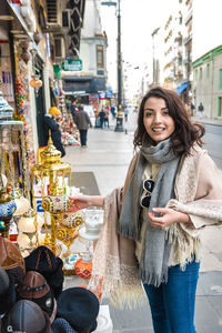 Portrait of smiling young woman standing in market