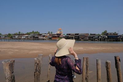 Rear view of woman standing against sky