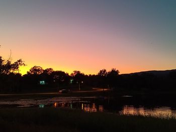 Scenic view of lake against romantic sky at sunset