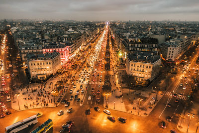 High angle view of illuminated street amidst buildings in city