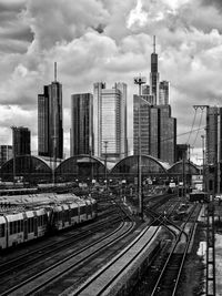 Railroad tracks in city against sky