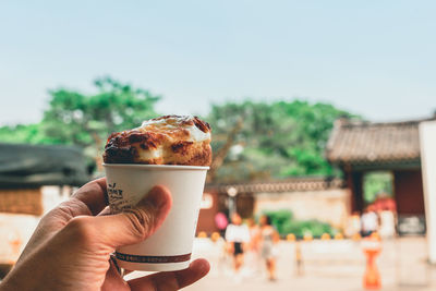 Midsection of person holding coffee cup