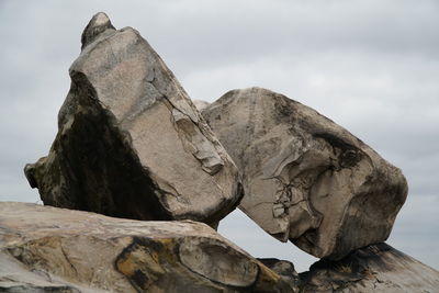 Low angle view of rock formation against sky