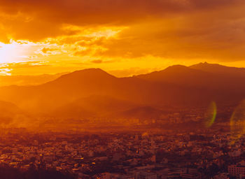 Aerial view of cityscape against sky during sunset