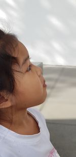 Close-up portrait of woman looking at shore against sky