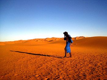 Full length of a man walking in desert