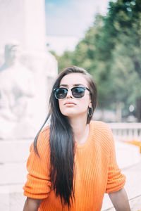 Portrait of woman wearing sunglasses standing outdoors