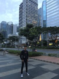 Full length of man on street against buildings in city