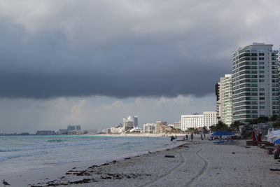 Panoramic view of beach and buildings against sky