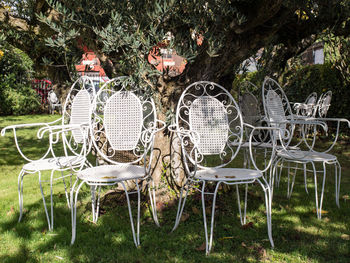 Empty chairs and table in park