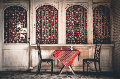 Empty chairs and table in building