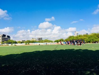Group of people on field against the sky