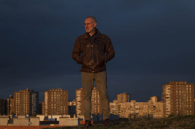 Adult man looking at city skyline of madrid, spain, during sunset