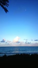 Scenic view of sea against blue sky