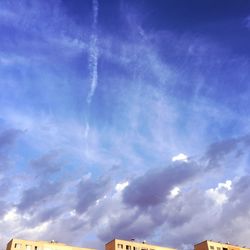 Low angle view of building against cloudy sky