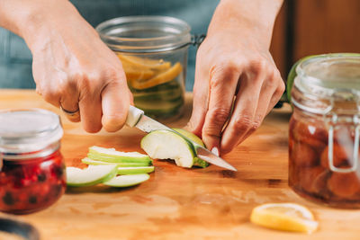 Cutting apple and lemon in the kitchen. fruit fermentation.