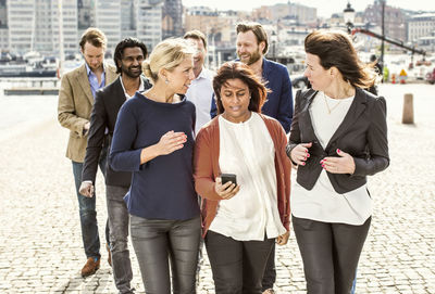 Business people discussing while walking on street