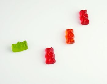 High angle view of multi colored candies against white background