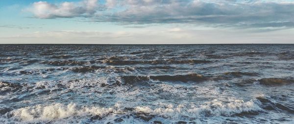 Scenic view of sea against cloudy sky