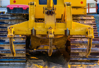 Close-up of yellow machinery at construction site