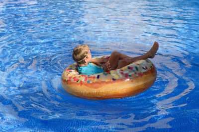 Young man relaxing in swimming pool