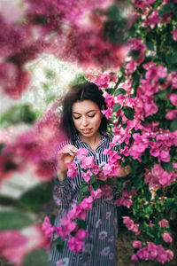 Portrait of beautiful woman with pink flower