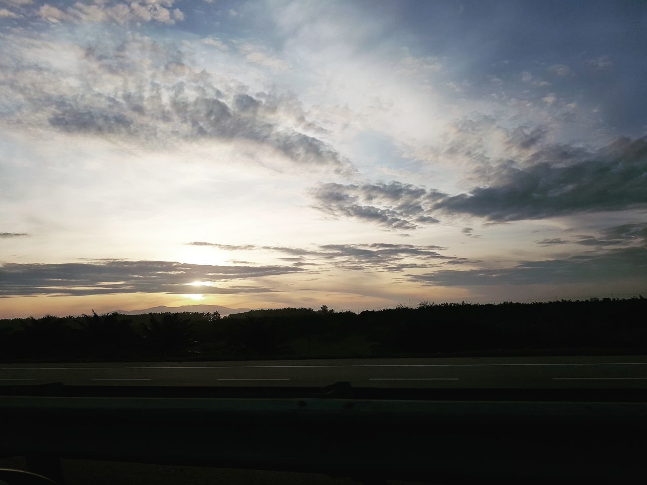 SILHOUETTE TREES BY LANDSCAPE AGAINST SKY DURING SUNSET