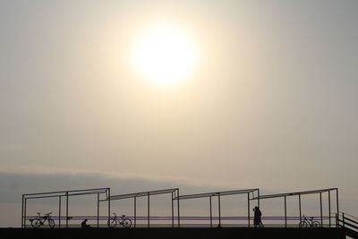 Silhouette man against sky during sunset