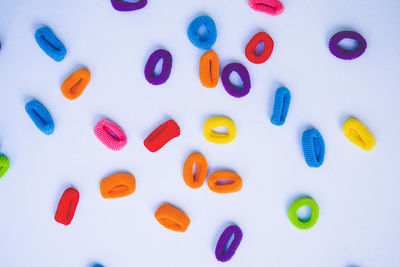 Directly above shot of multi colored candies on white background