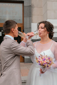 Bride and groom holding wedding glasses with champagne. celebrating just married. lovely coule. love