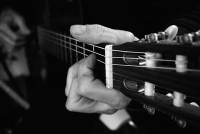 Close-up of hand playing guitar