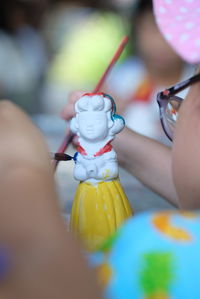 Close-up of hand holding figurine