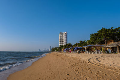 Scenic view of beach against clear blue sky