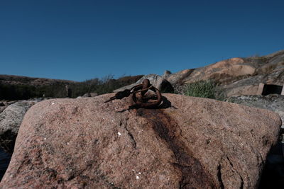 View of rocks against clear blue sky