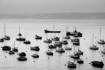 Scenic view of boats in seascape against clear sky