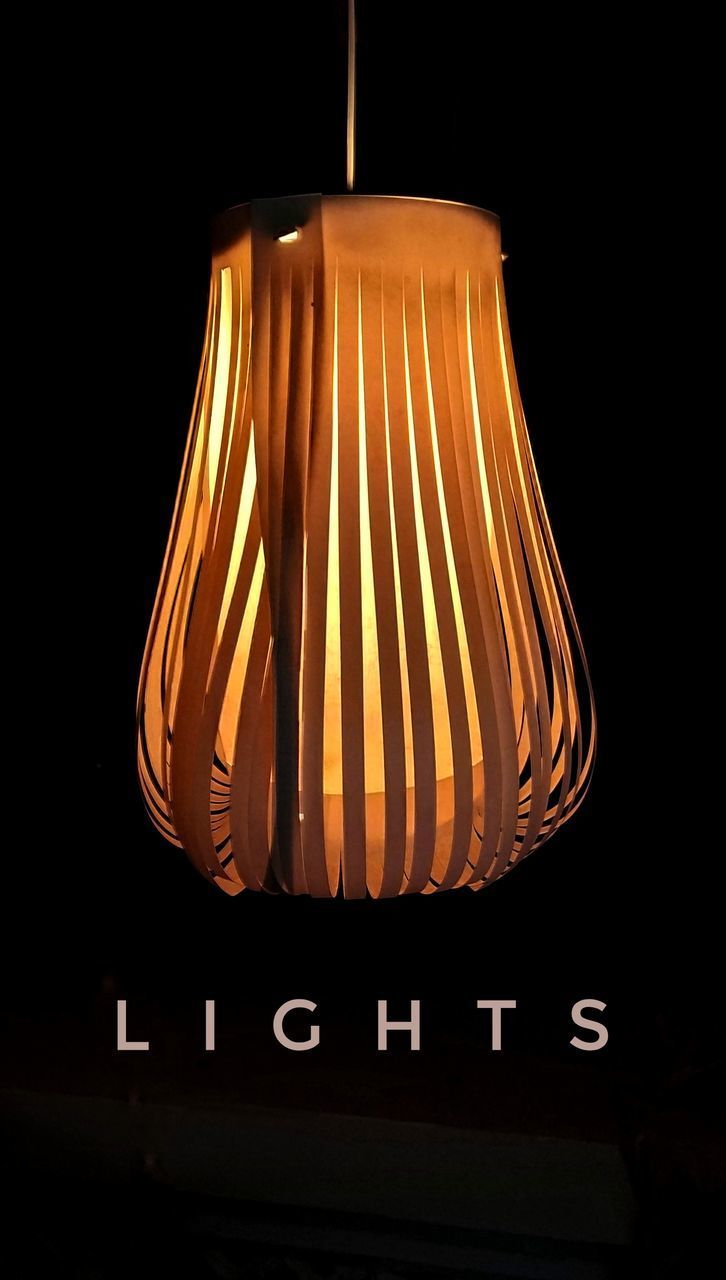 LOW ANGLE VIEW OF ILLUMINATED ELECTRIC LAMP AGAINST BLACK BACKGROUND