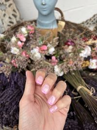 Cropped hand of woman holding bouquet