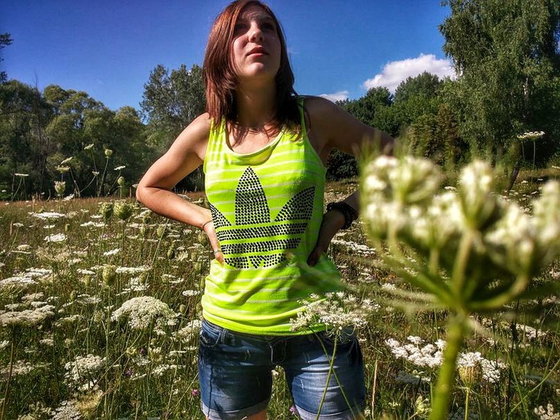 FULL LENGTH OF WOMAN STANDING ON PLANT