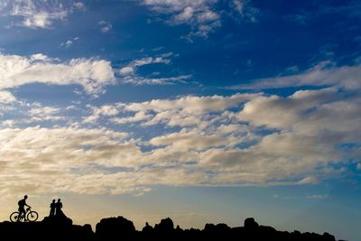 Low angle view of silhouette trees against sky at sunset